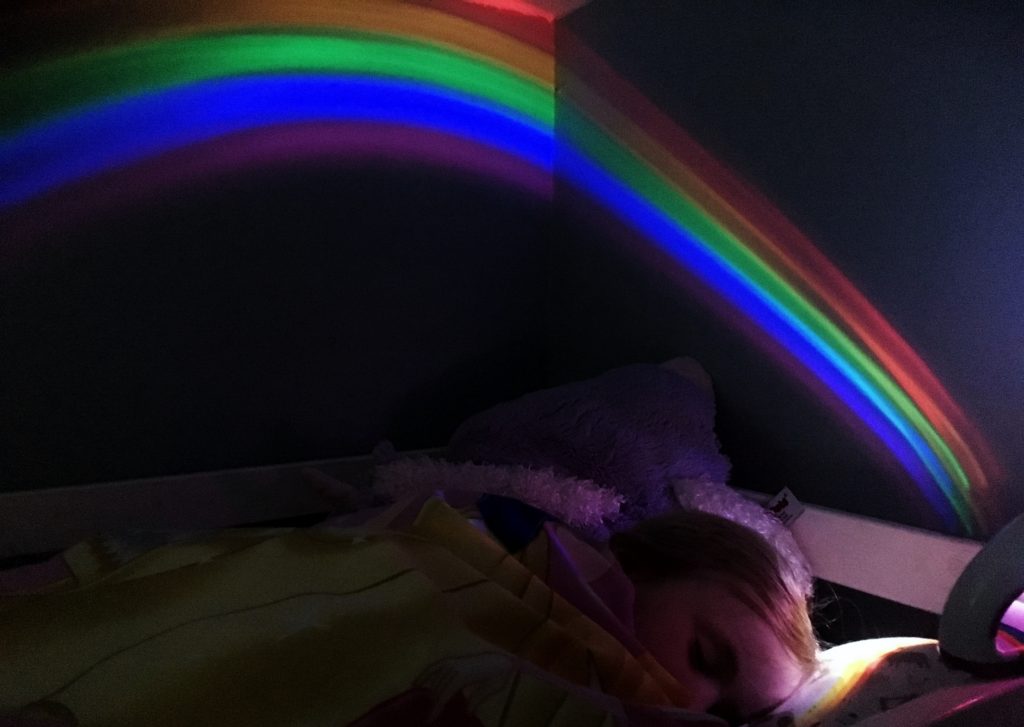 fast asleep with rainbow projector
