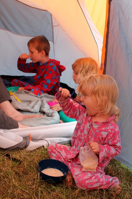 3 kids eating breakfast camping